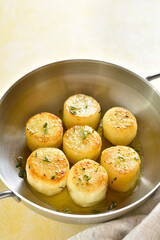Fondant potatoes in pan