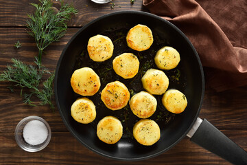 Fondant potatoes in frying pan