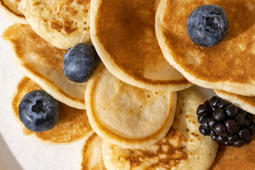 tasty pancakes and berries on white plate