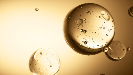 Transparent bubbles float in yellow background