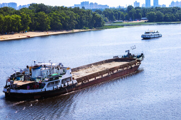 A cargo ship goes along the Dnieper river in the city of Kiev