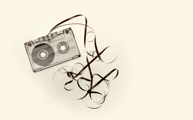 Old audio cassette with curl tap. Vintage retro beige color tone background. Flat lay, top view.