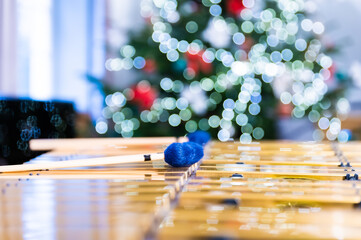 Vibraphone sticks lying on this percussion instrument. In the background, blurry, out-of-focus lights of the Christmas tree.