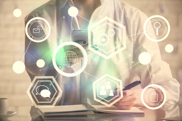 Double exposure of social network sketch hologram and woman holding and using a mobile device.