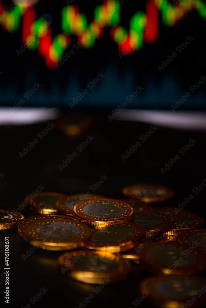 Wall mural Pile of  Bitcoin gold coins and defocused chart background, Virtual cryptocurrency concept