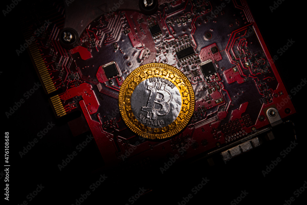 Poster top view of bitcoin coins on a red video card background, blockchain and bitcoin mining concept