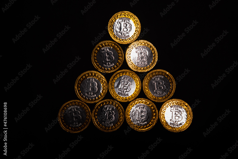 Poster top view of bitcoin coins on a red video card background, blockchain and bitcoin mining concept