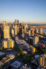 Fototapeta na wymiar Seattle, Washington, USA - June 4 2021: Seattle downtown skyline and Mount Rainier during summer sunset. View from Seattle needle.