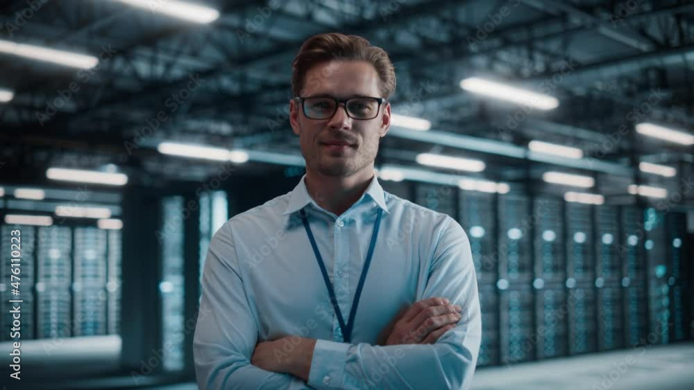 Poster big data center portrait of smiling chief technology officer wearing glasses walks into focus, looks