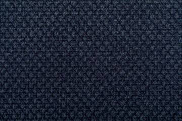 Black fabric texture. Furniture upholstery textiles. Embossed pattern. Woven fibers. The material...