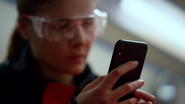 Emergency medical doctor texting on mobile phone in ambulance car