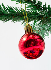 Decorative red ball that hangs as a decoration on the branches of the Christmas tree.
