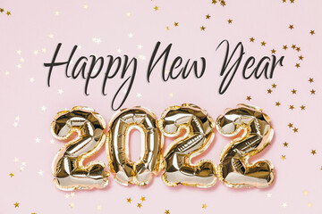 Happy New year 2021 celebration. Gold and silver foil balloons numeral 2021, party decoration and confetti stars on beige and Set Sail Shampagne background. Flat lay, christmas creative concept