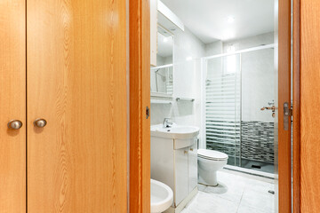 Naklejka na ściany i meble Entrance to a bathroom with shower and built-in wardrobe in a vacation rental apartment