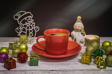 New Year's mood with a cup of coffee, decorations and a snowman