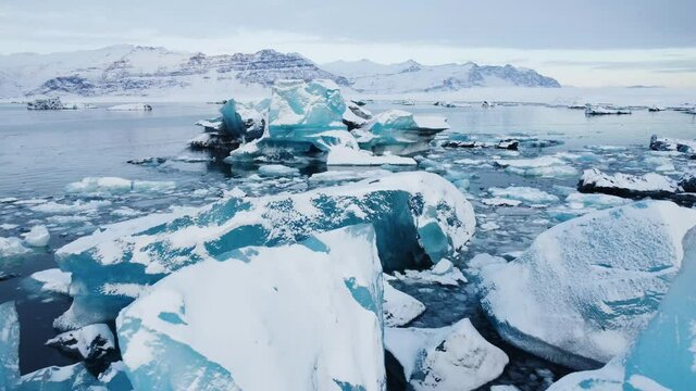 Blue Icebergs floating and melting in Jokulsarlon Ice Lagoon. Climate Change Global Warming problem. Iceland.