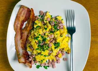 scramble eggs top with diced ham and parsley