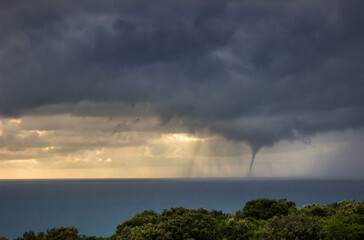 Tornadic waterspout on the sea on a stormy day - obrazy, fototapety, plakaty