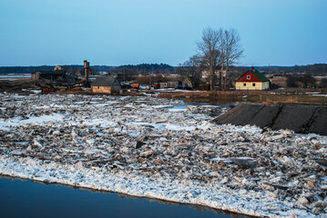 Floods in spring. Pieces of water and ice are close to the buildings. Zlekas, Latvia