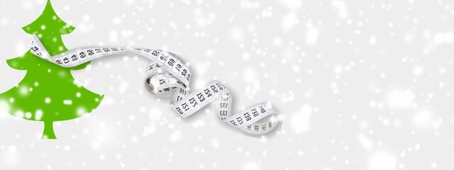 Exercise, Fitness and Working Out Merry Christmas and Happy new year concept. Measuring tape and Christmas tree