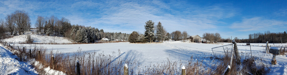 A winter countryside landscape with farm in the province of Quebec, Canada