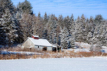 A winter countryside landscape with farm in the province of Quebec, Canada