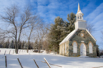 Winter landscape with the nice Frost Church. Magnificent little stone church