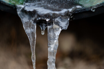 icicles hanging from a frozen pipe