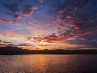 Fototapeta na wymiar Colorful sunset with dramatic sky clouds over Knysna lagoon