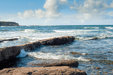 Rough stone coast line and powerful waves in the ocean. Spanish point part of Wild Atlantic Way...