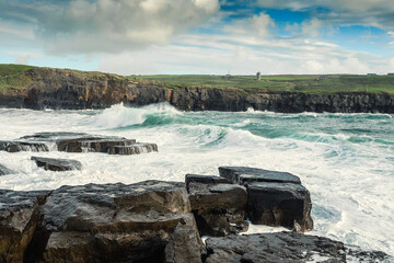 Powerful waves crushing against Cliffs and rough stone coastline of West coast of Ireland. Doolin...