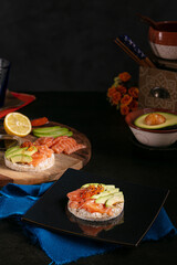 Puffed rice spread with raw salmon and avocado