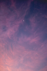 Beautiful and colorful sunset sky with crescent Moon, Venus and clouds