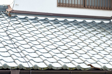 Roof tile lightly dusted with snow in Japan
