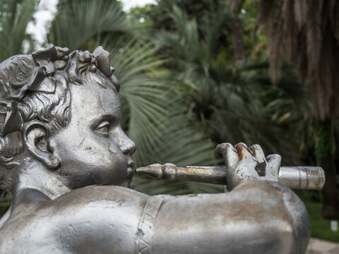 Russia Sochi 23.06.2019. The statue of a boy plays a pipe. Park Arboretum