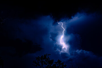 Night sky with lightning in a thunderstorm. Dramatic weather.