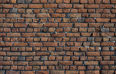 Old brick wall, old texture of red stone blocks closeup.