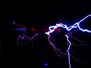 Electric discharge of lightning with the outlines of electric coils in the dark. Noise, film grain