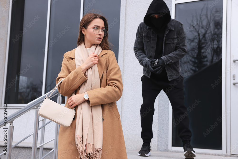 Canvas Prints Man with knife stalking young woman near building