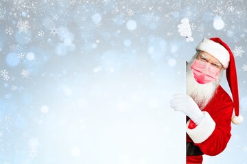 Santa Claus With Protective Mask Pointing Blank Billboard