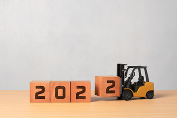 Happy new year 2022 . new year background industrial concept, diecast forklift carrying box to complete 2022 text. © Marsyago
