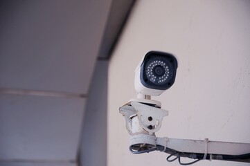 Security white CCTV (Closed-circuit television) camera in the office building.