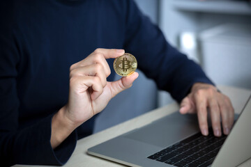 Male using laptop investment in bitcoin crypto currency blockchain technology trading concept