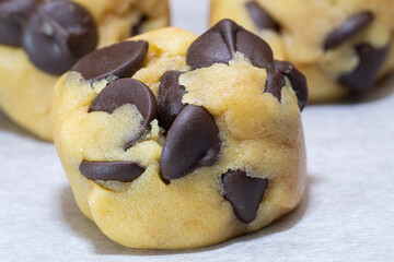 Dough balls of chocolate chip cookie filled with chocolate chips