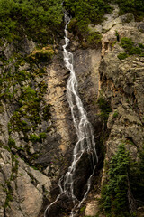 Obraz na płótnie Canvas Unknown Water Fall Cascades Down Rocky Cliff