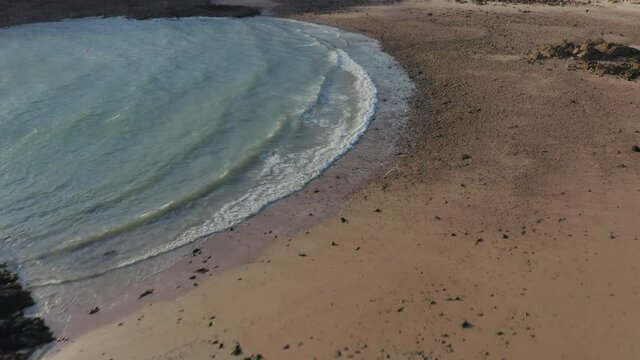 An aerial drone shot of Portelet beach on the south coast of Jersey, Channel islands in the summer.