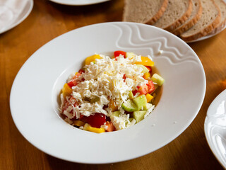 Vegetable salad with fresh tomatoes, cucumbers, bell pepper and feta cheese