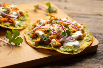 Chicken tinga tostadas with cheese and avocado. Mexican food