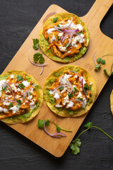 Chicken tinga tostadas with cheese and avocado. Mexican food