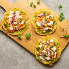 Chicken tinga tostadas with cheese and avocado. Mexican food
